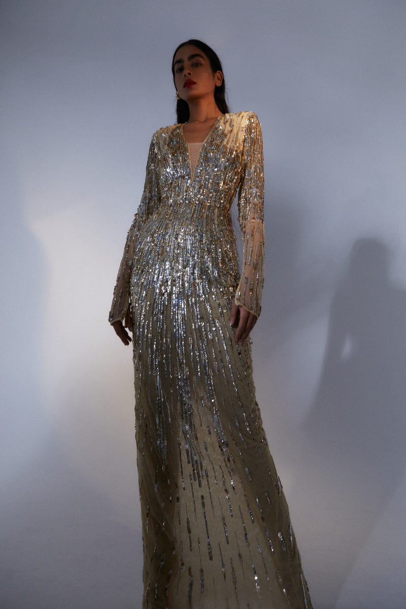 Campaign image of model wearing Rachel Gilbert Blanca Gown in gold