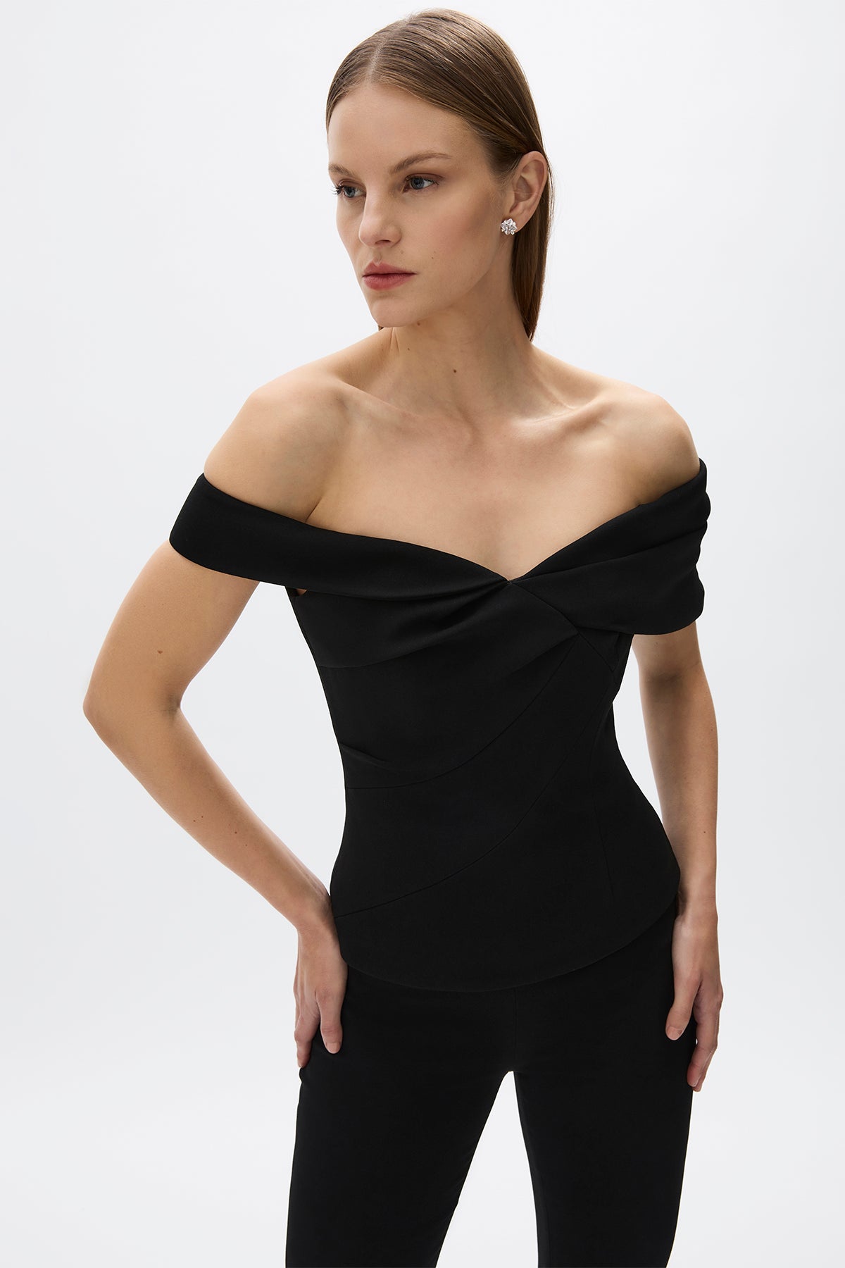 Mattie Top: sleek black fitted top with off-the-shoulder detail, designed for a flattering fit and versatile styling.