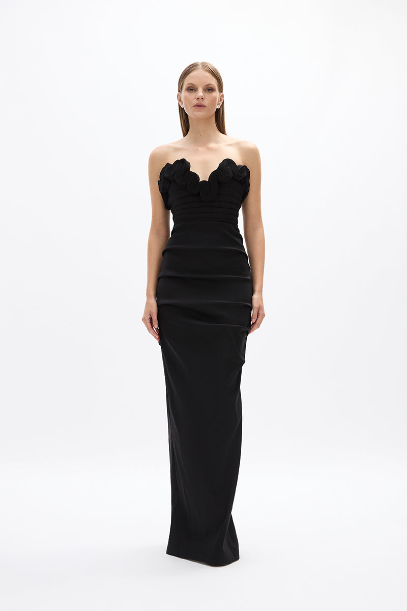 Ren Gown: chic full-length black gown featuring ruched fabric and wave detail across décolletage. Perfect for evening events.  