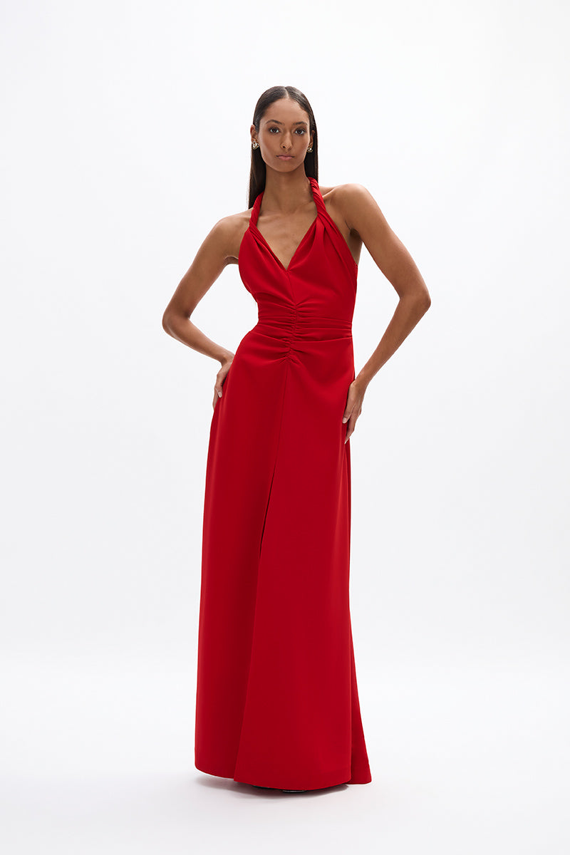 Soren Gown: halter style red gown featuring twist neck detail, fitted waist and relaxed skirt, perfect for day time events.