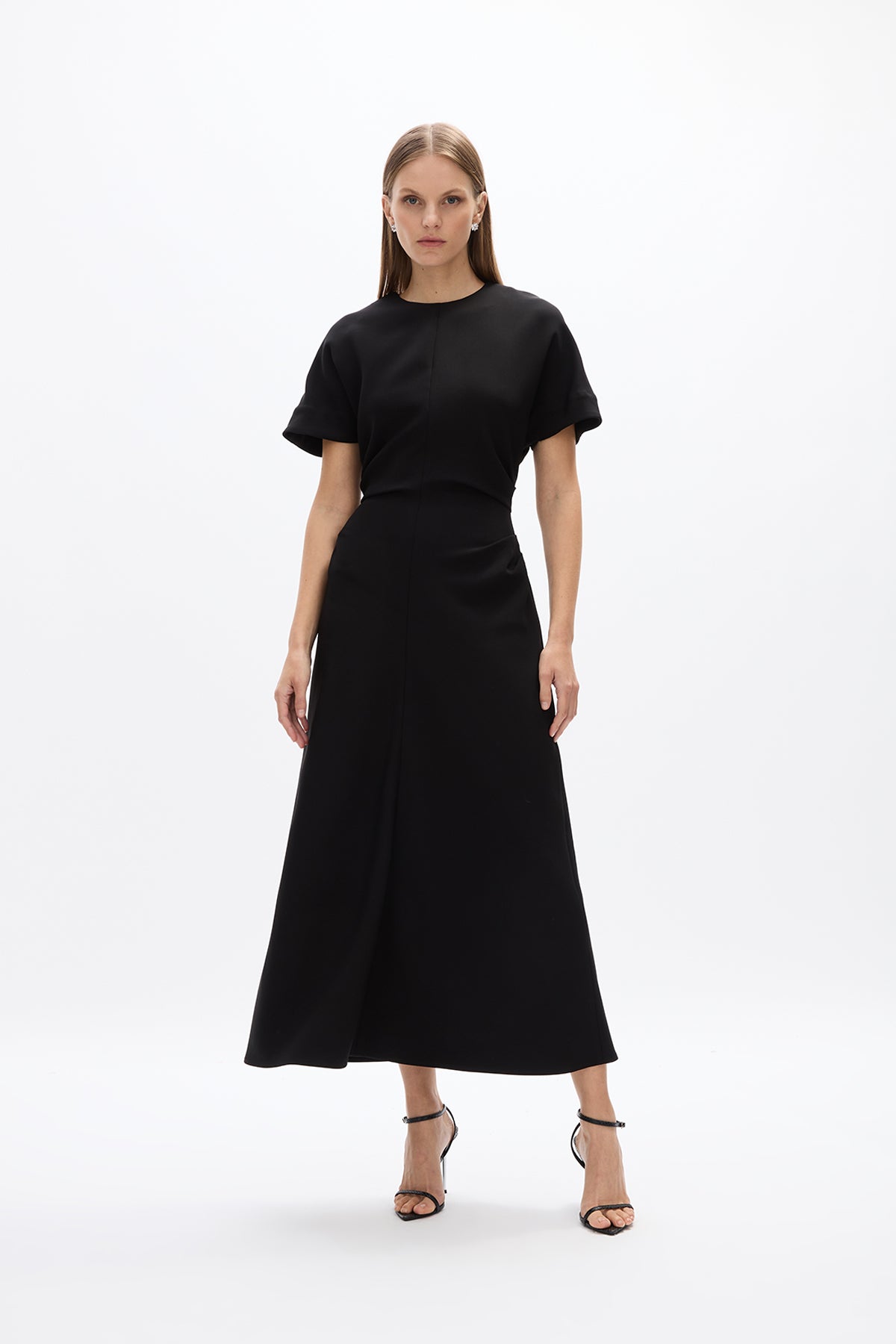 Orion Dress: Elegant black mid-length dress with short sleeve and flowing skirt, perfect for day to night wear.