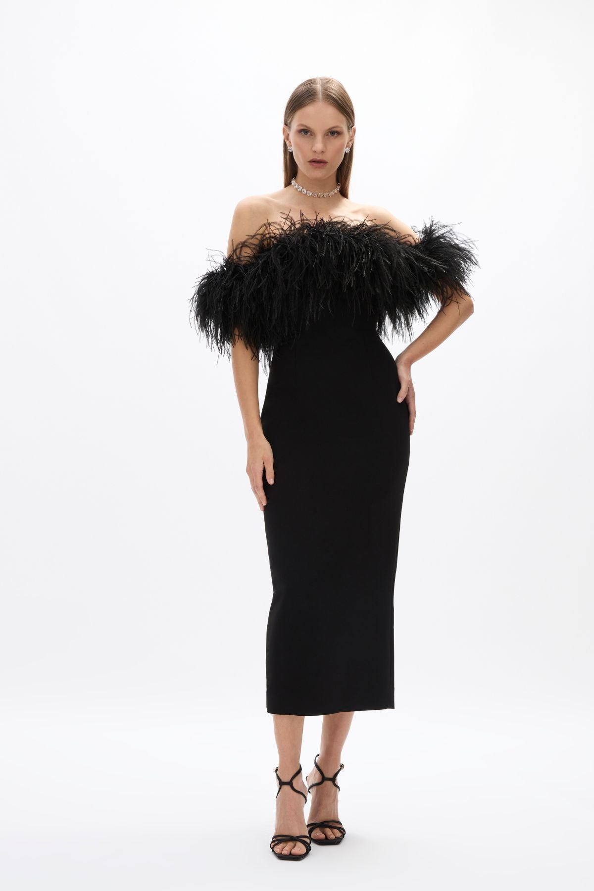 Link Dress: elegant black mid-length dress featuring feather detail and back split, perfect for cocktail events.