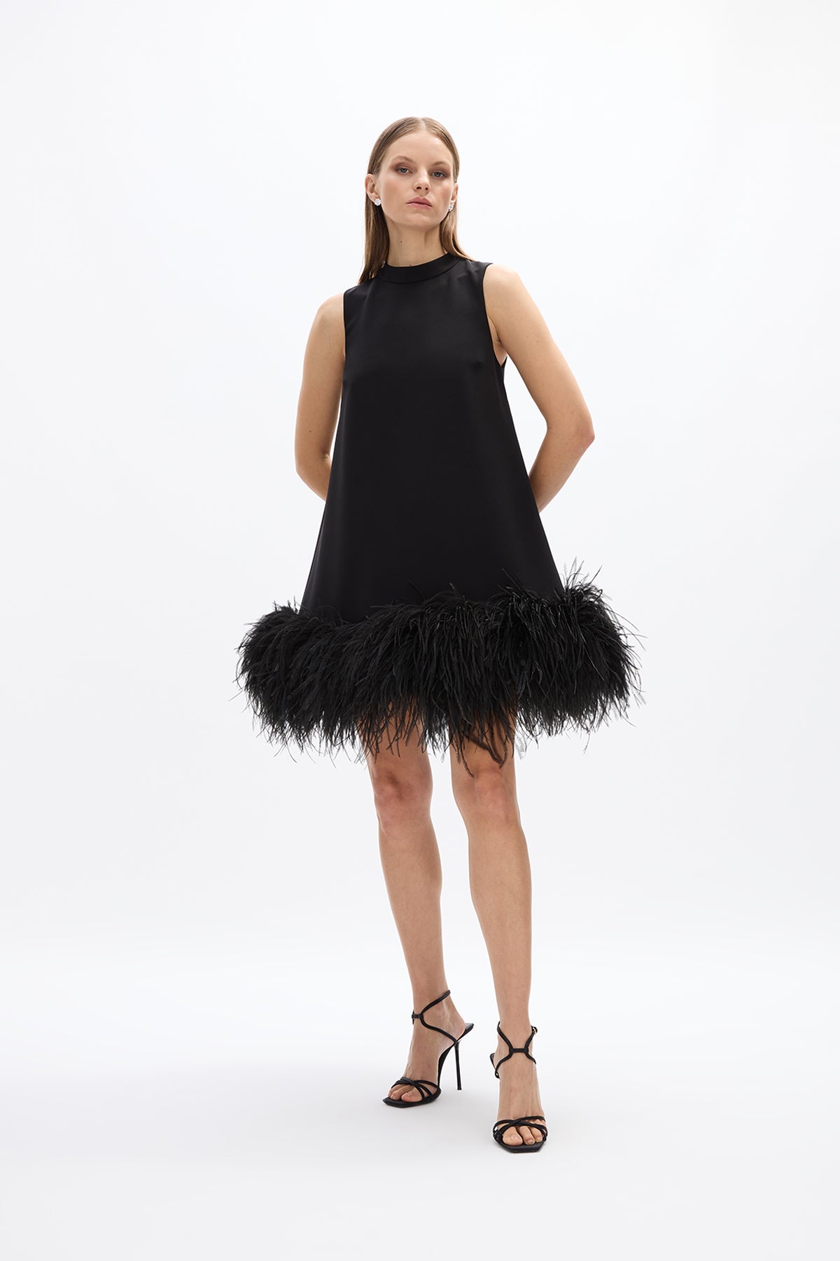 Linc Mini: chic black A-line mini dress featuring a voluminous feather hem for a playful touch.